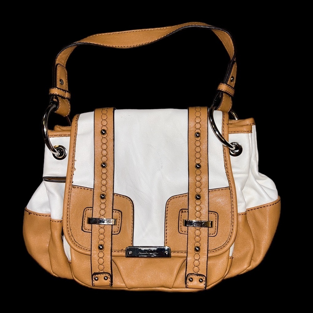 Franco Sarto tan and cream saddle style bag. Has a tear in the pocket inside